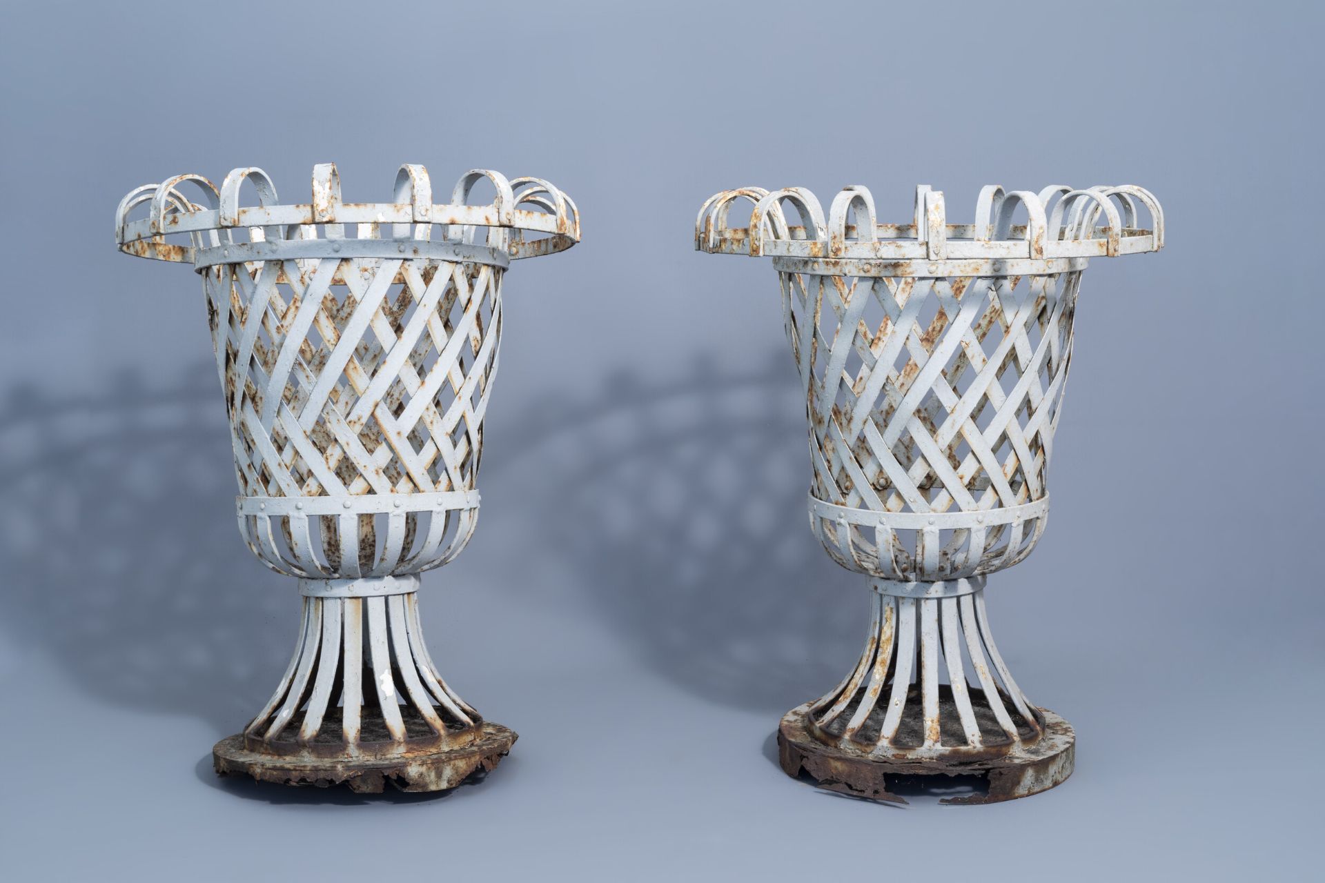 A pair of wrought iron reticulated garden urns, ca. 1900