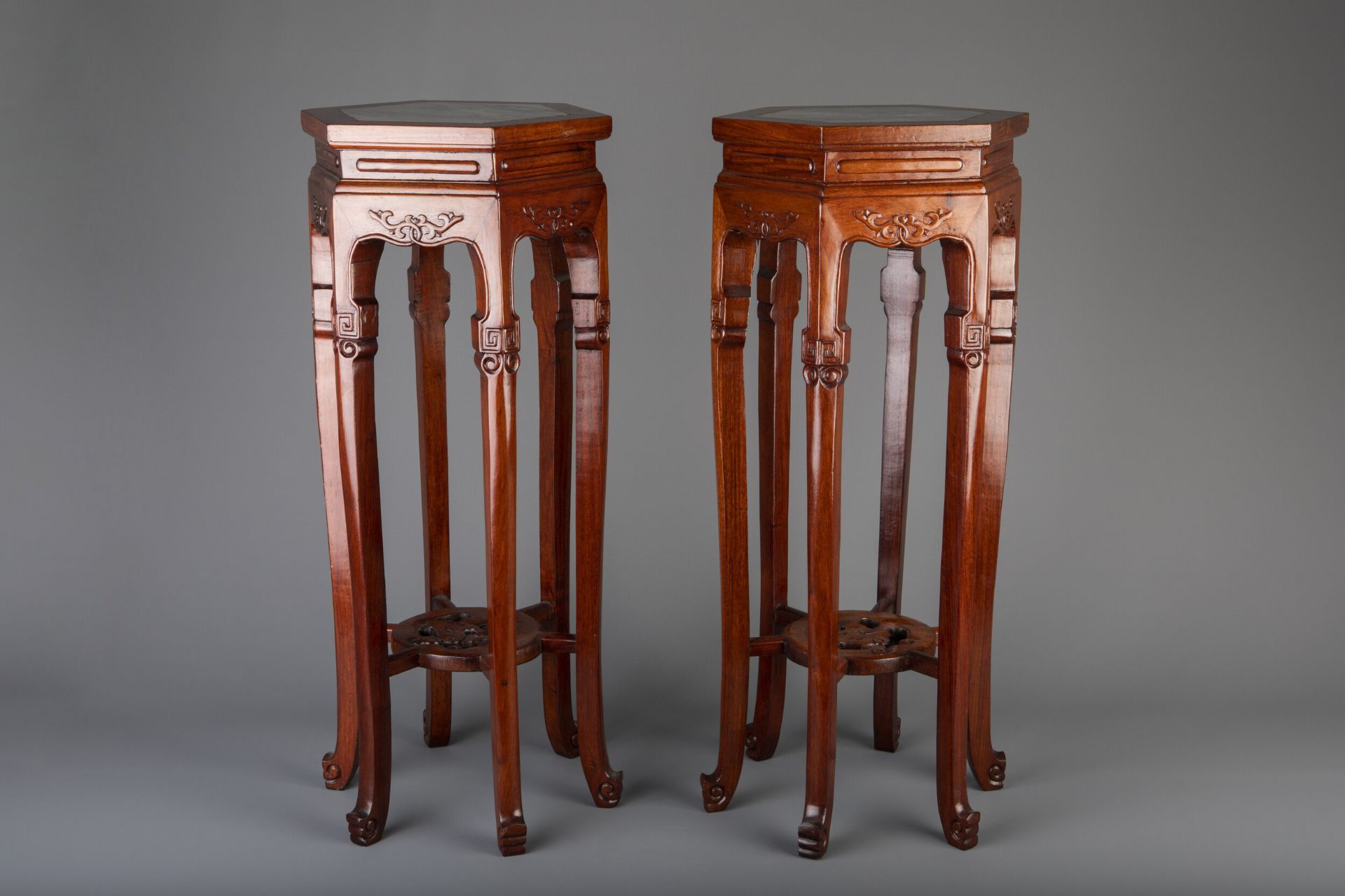 A pair of Chinese carved wood and marble hexagonal vase stands, 20th C.