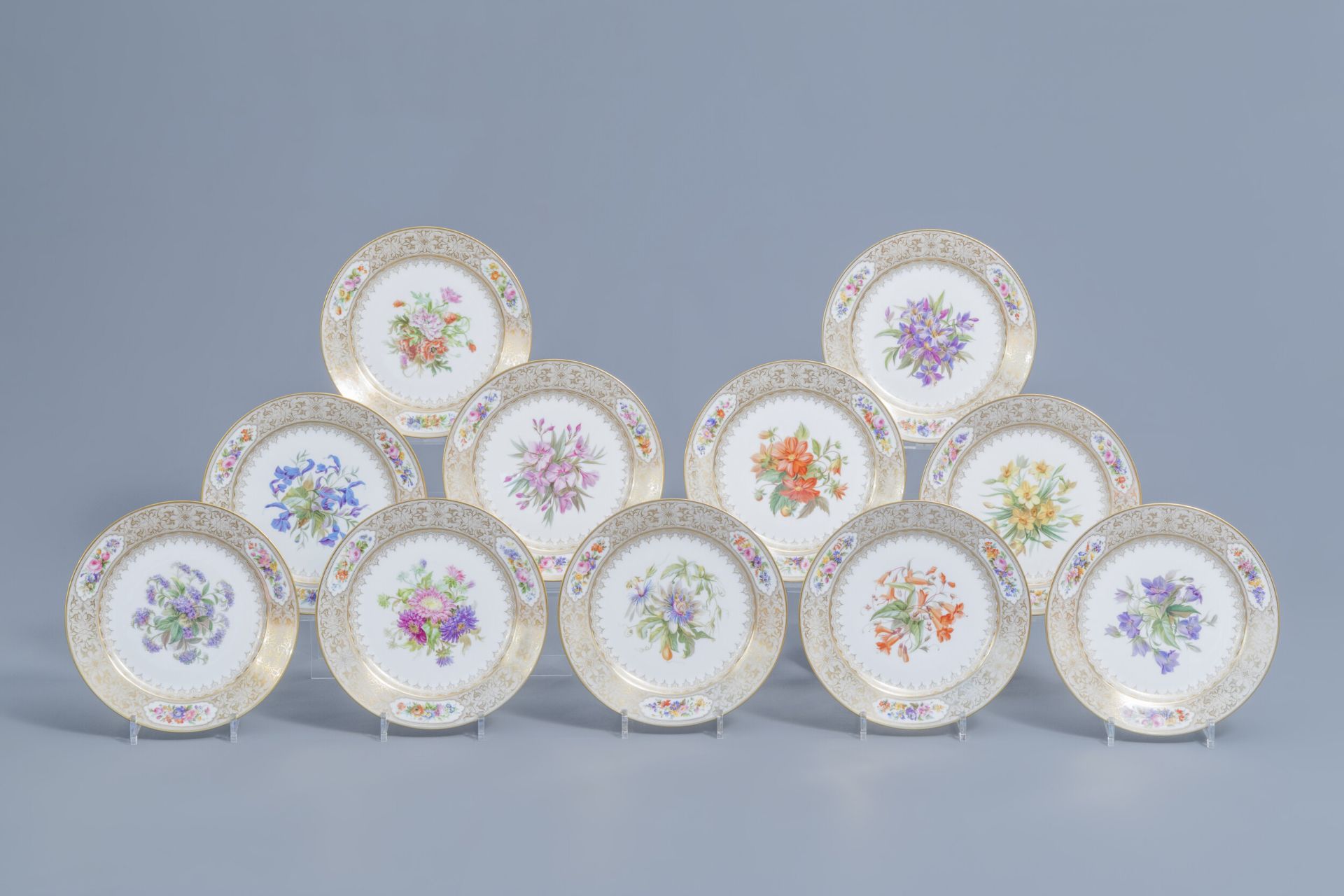 A set of eleven French plates with gilt and polychrome floral design, Svres mark, 19th C.