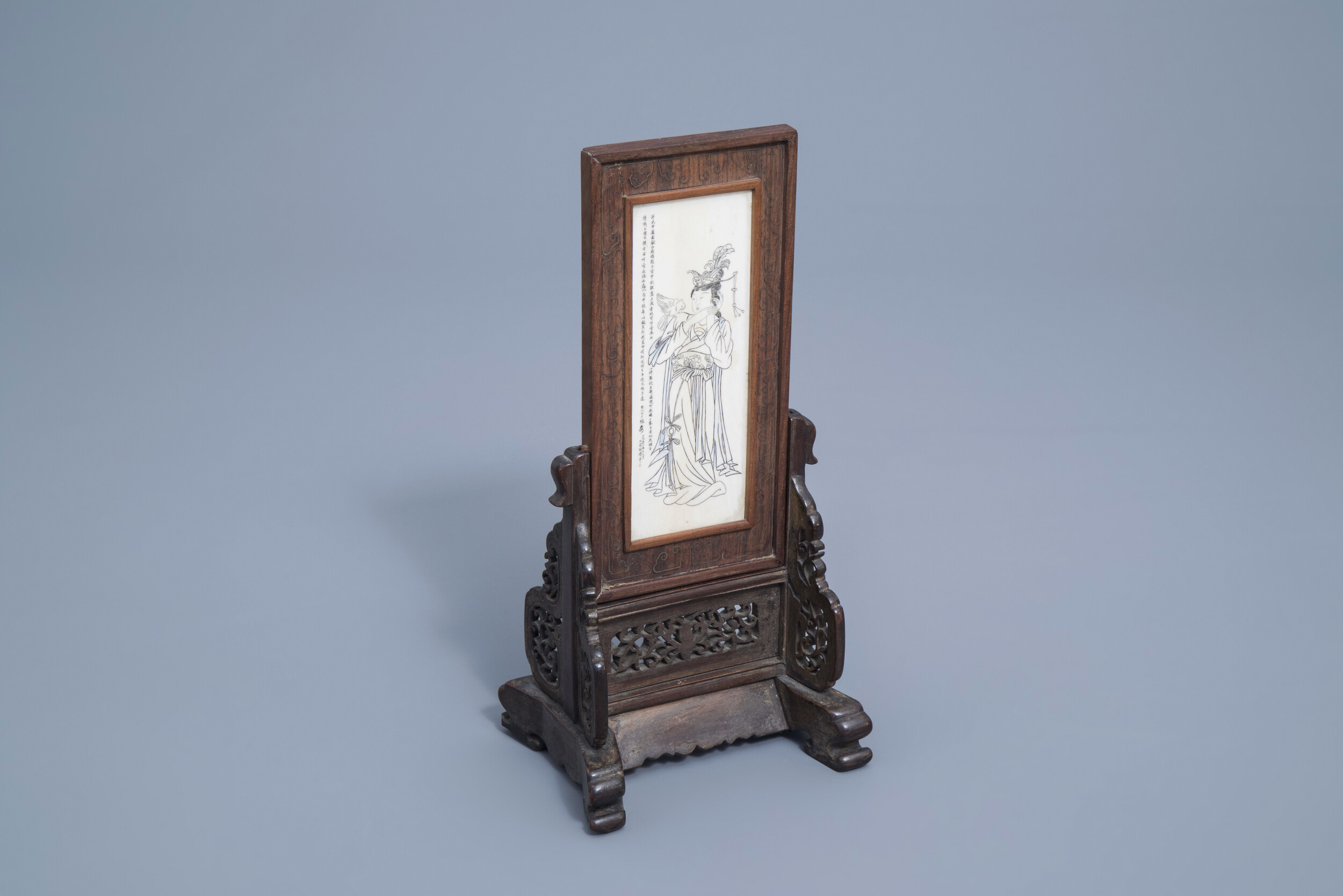 A Chinese wooden table screen with an ivory plaque depicting a lady and a butterfy, ca. 1920