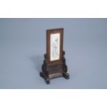 A Chinese wooden table screen with an ivory plaque depicting a lady and a butterfy, ca. 1920