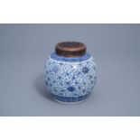 A Chinese blue and white 'lotus scroll' jar with wooden cover, Qianlong