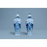 A pair of Chinese blue and white vases and covers with boys and antiquities, Qianlong mark, 19th C.