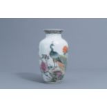 A Chinese famille rose vase with a peacock among blossoming branches, Republic, 20th C.