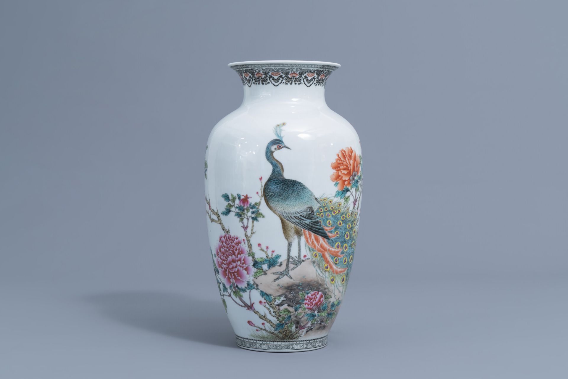 A Chinese famille rose vase with a peacock among blossoming branches, Republic, 20th C.