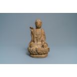 A Chinese sandstone figure of Buddha with traces of polychrome and gilt decoration, Qing