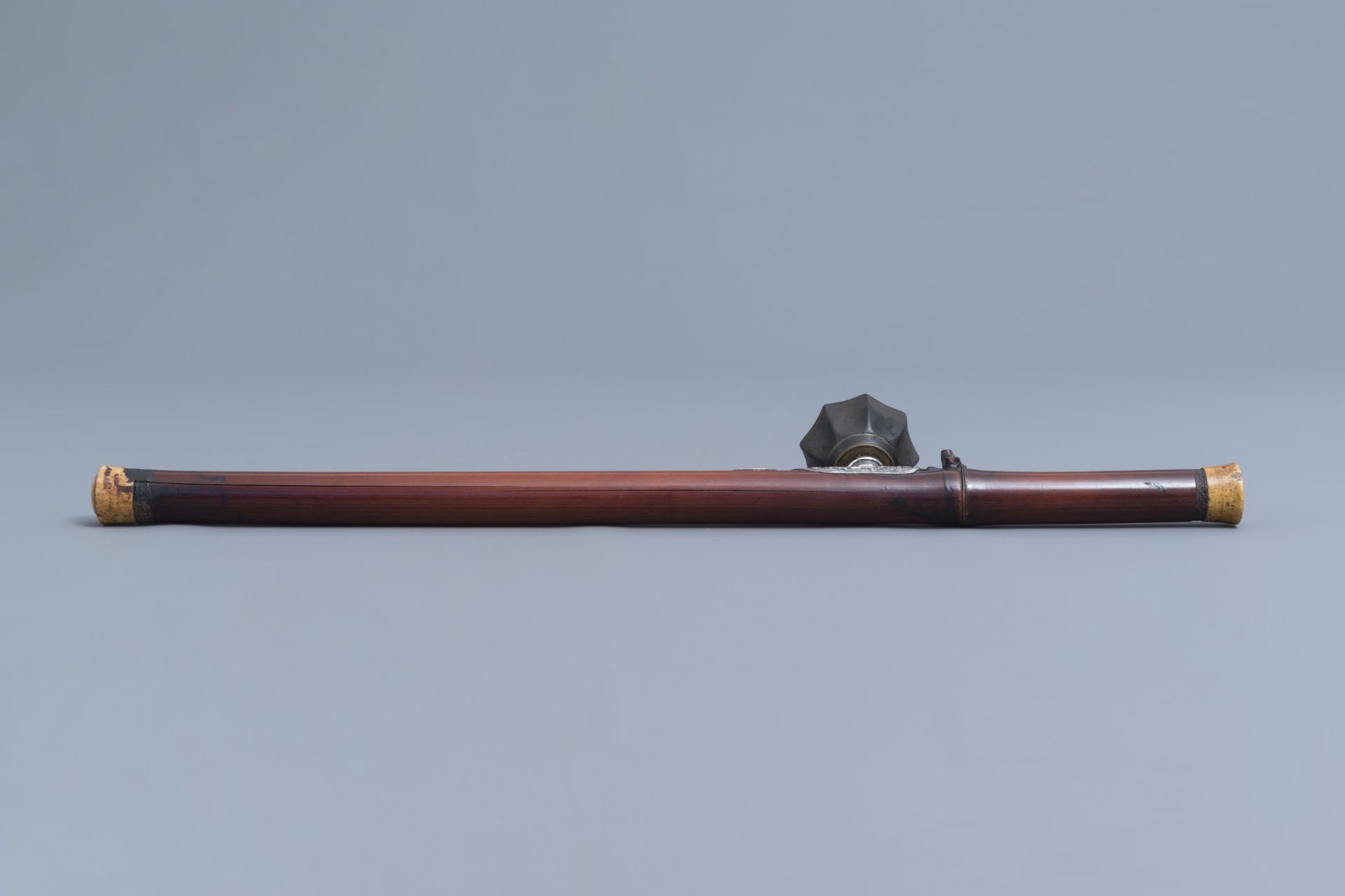 A Chinese bamboo opium pipe with a silver saddle, ivory endpiece and stoneware damper, 19th C. - Image 5 of 12