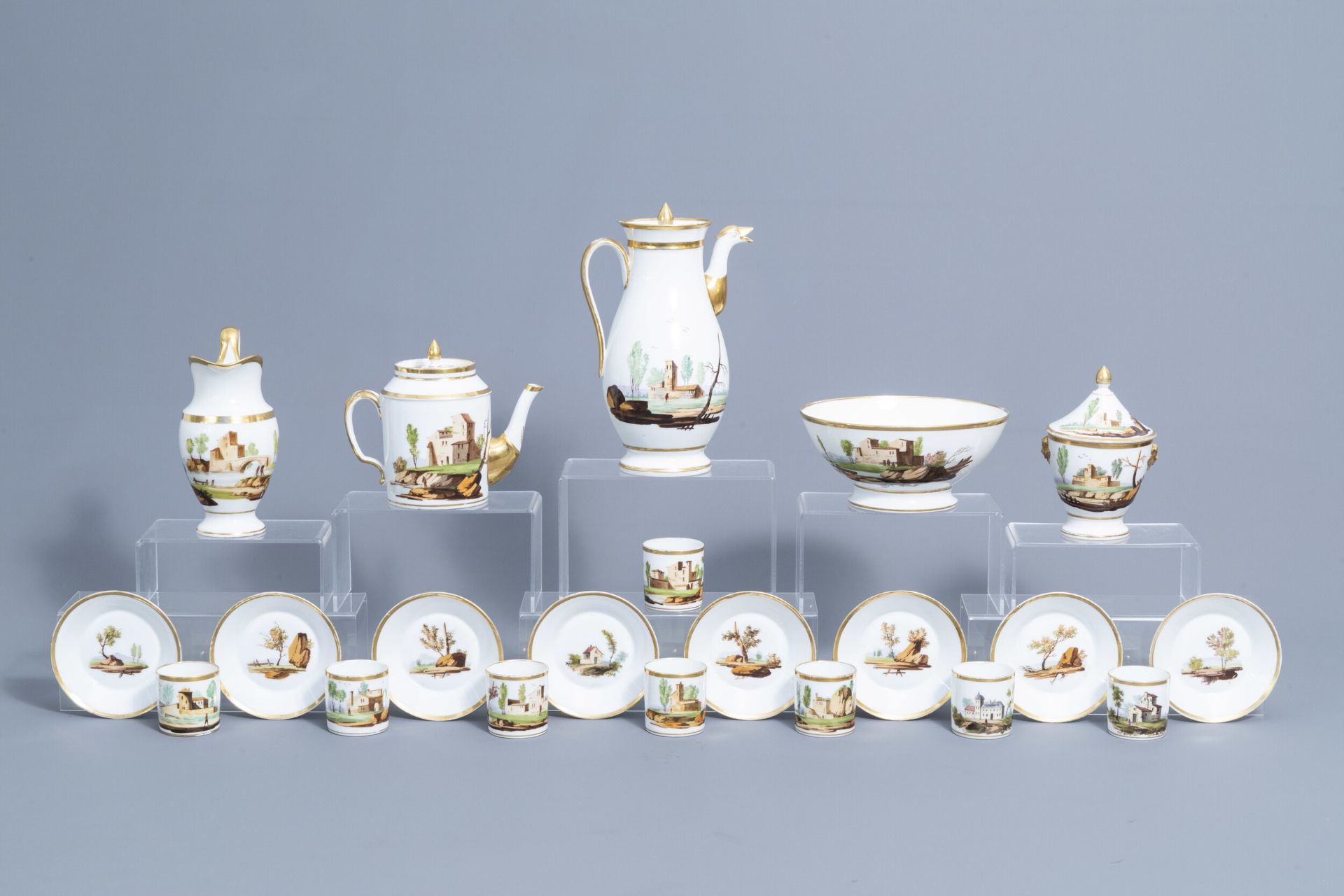 A 21-piece Paris polychrome and gilt porcelain coffee and tea service with landscapes, 19th C.