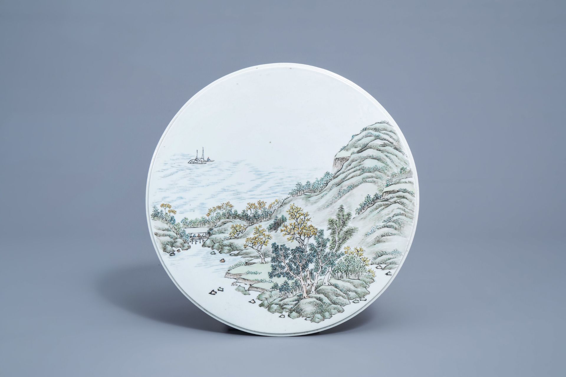 A round Chinese qianjiang cai plaque with a river landscape, 20th C.