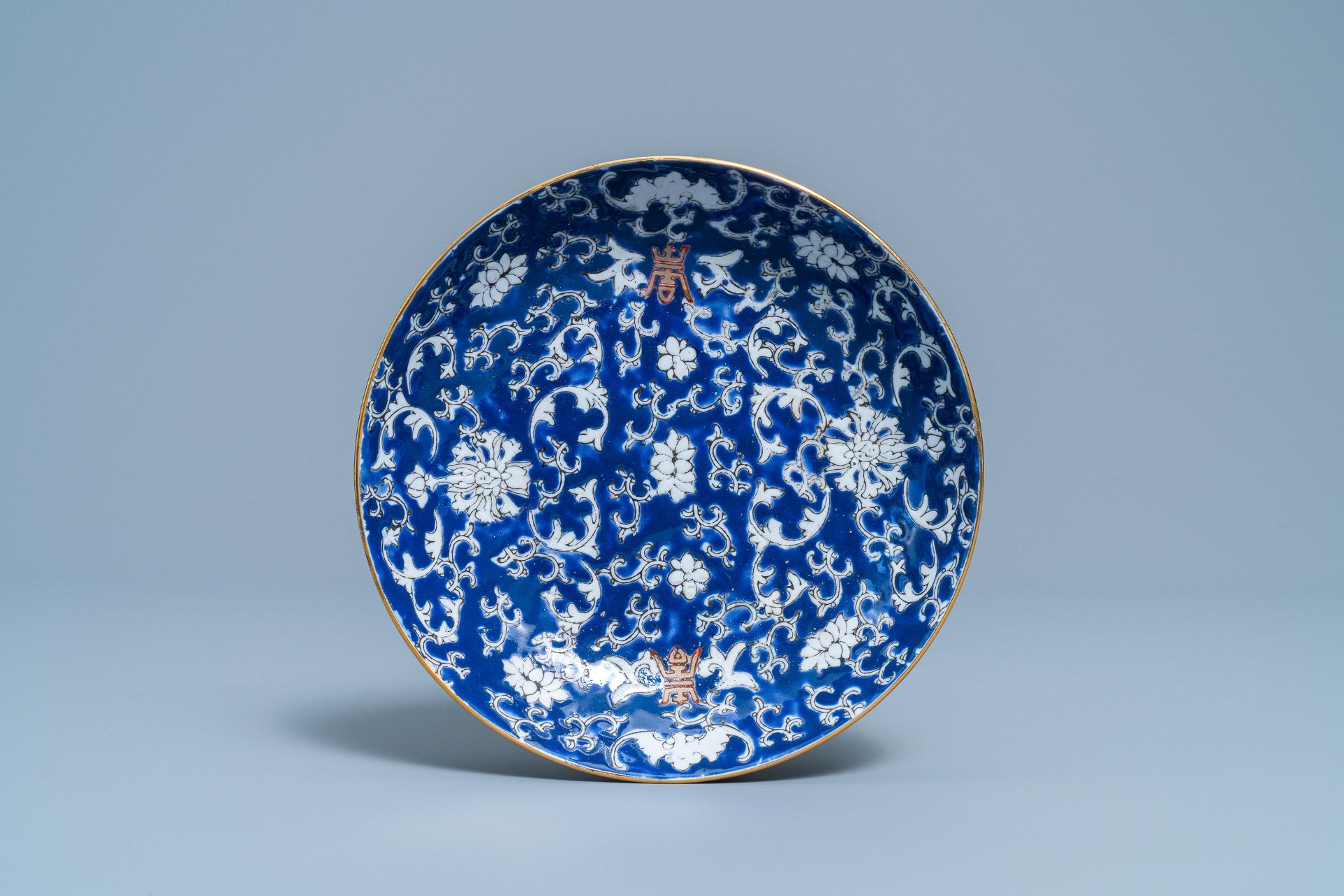 A pair of Chinese famille rose 'millefleurs' plates and a blue ground plate, 19th/20th C. - Image 4 of 5