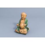 A Chinese sancai-glazed figure of Buddha on a lotus trone, Qing