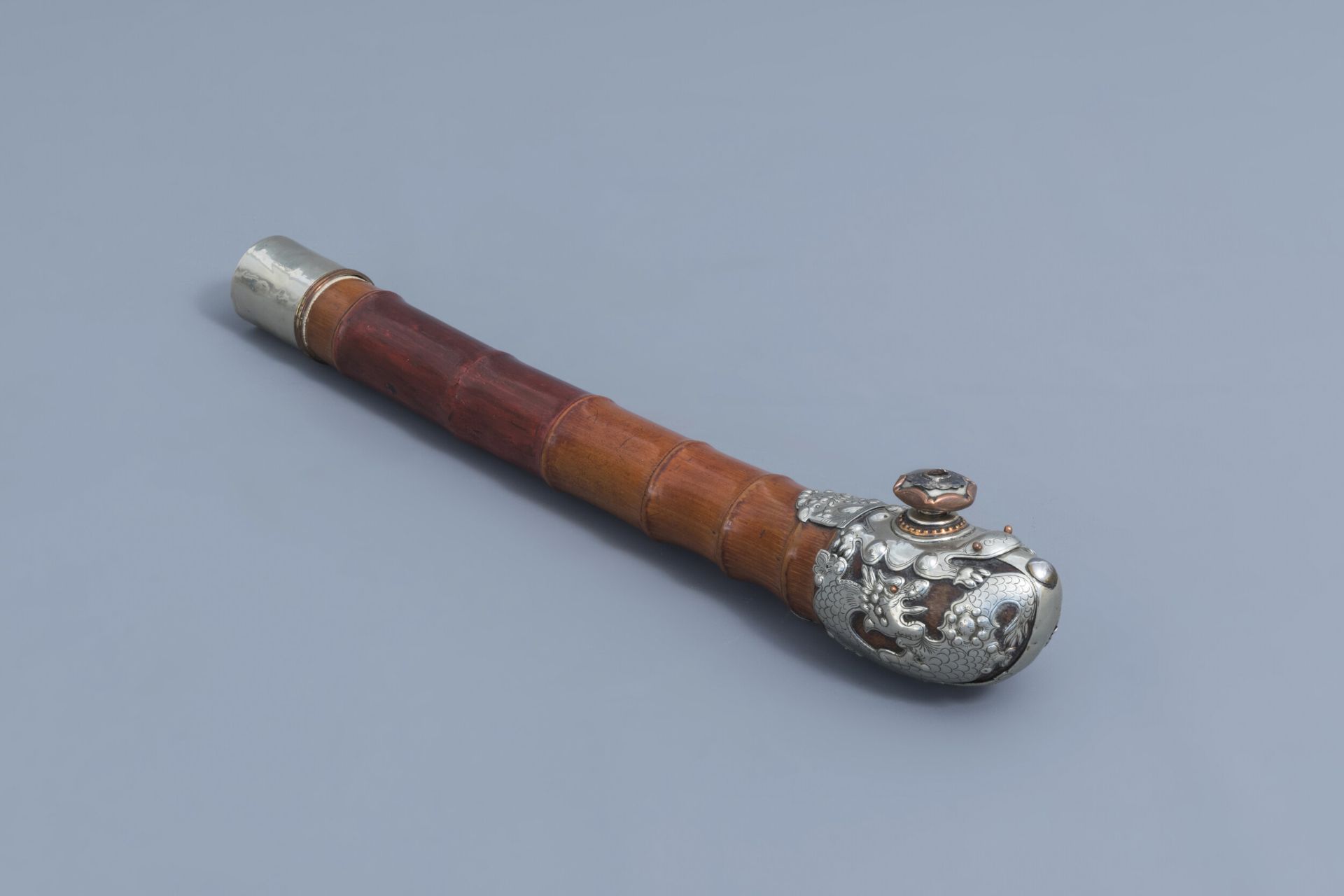 A Chinese bamboo silver and copper mounted opium pipe, 19th C.