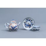 A Chinese Imari style teapot and cover and a cup and saucer with boys, Kangxi/Qianlong