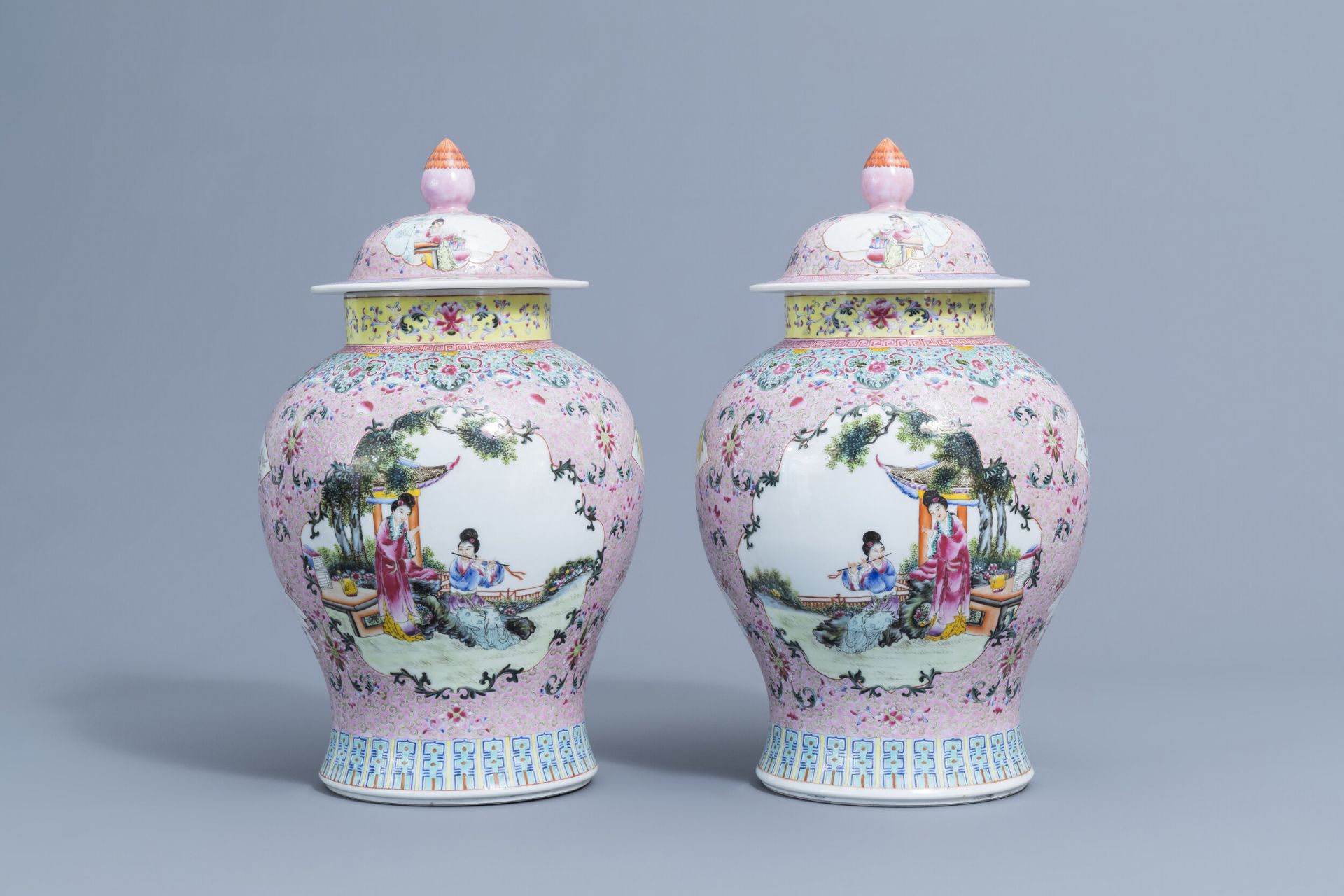 A pair of Chinese famille rose vases and covers with ladies, Qianlong mark, 20th C.