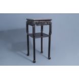 A Chinese carved wooden stand with marble top, 19th/20th C.