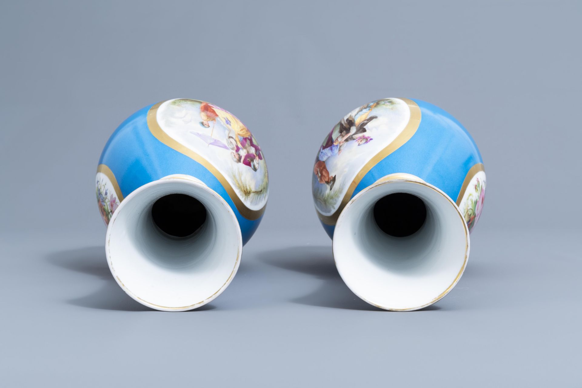 A pair of French 'bleu celeste' ground vases with gallant scenes and a German gilt charger, 20th C. - Image 11 of 24