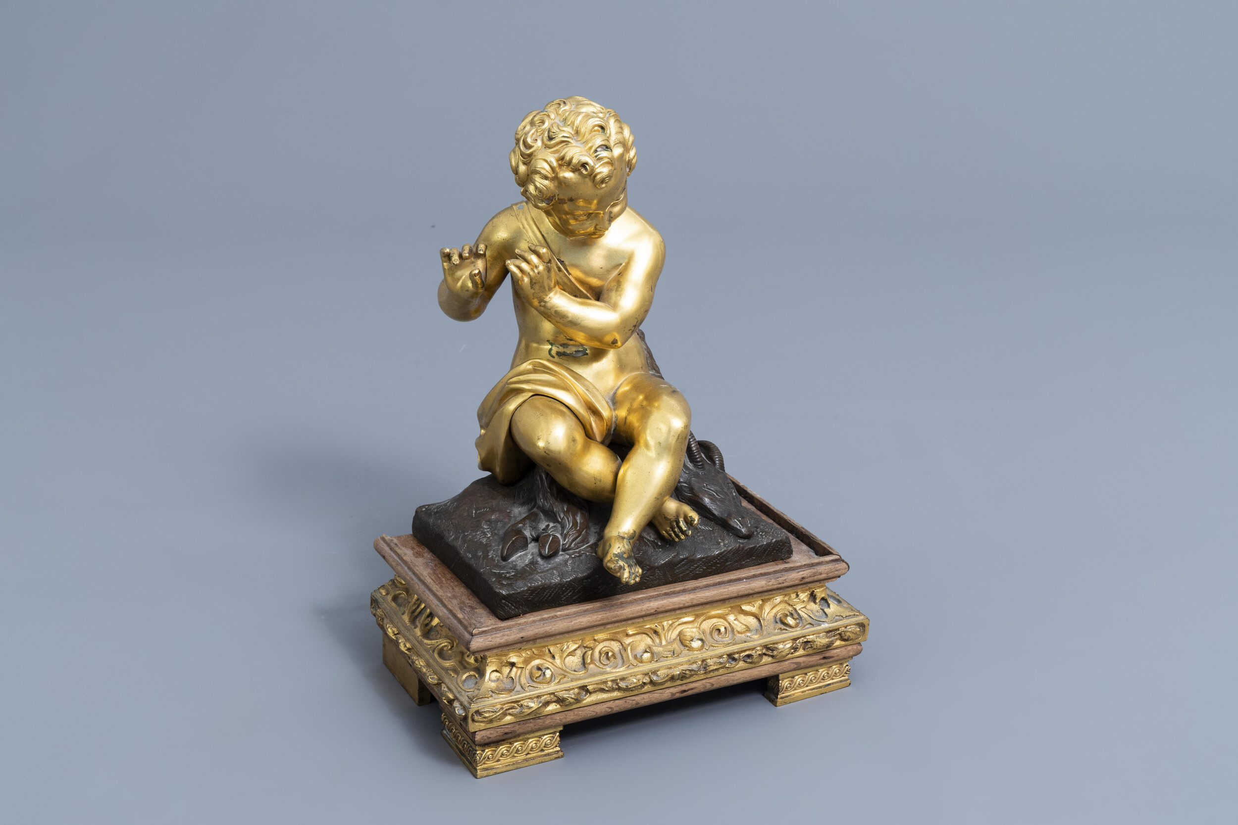 French school: A flute player with a goat, gilt and patinated bronze on a gilt mounted wooden base,