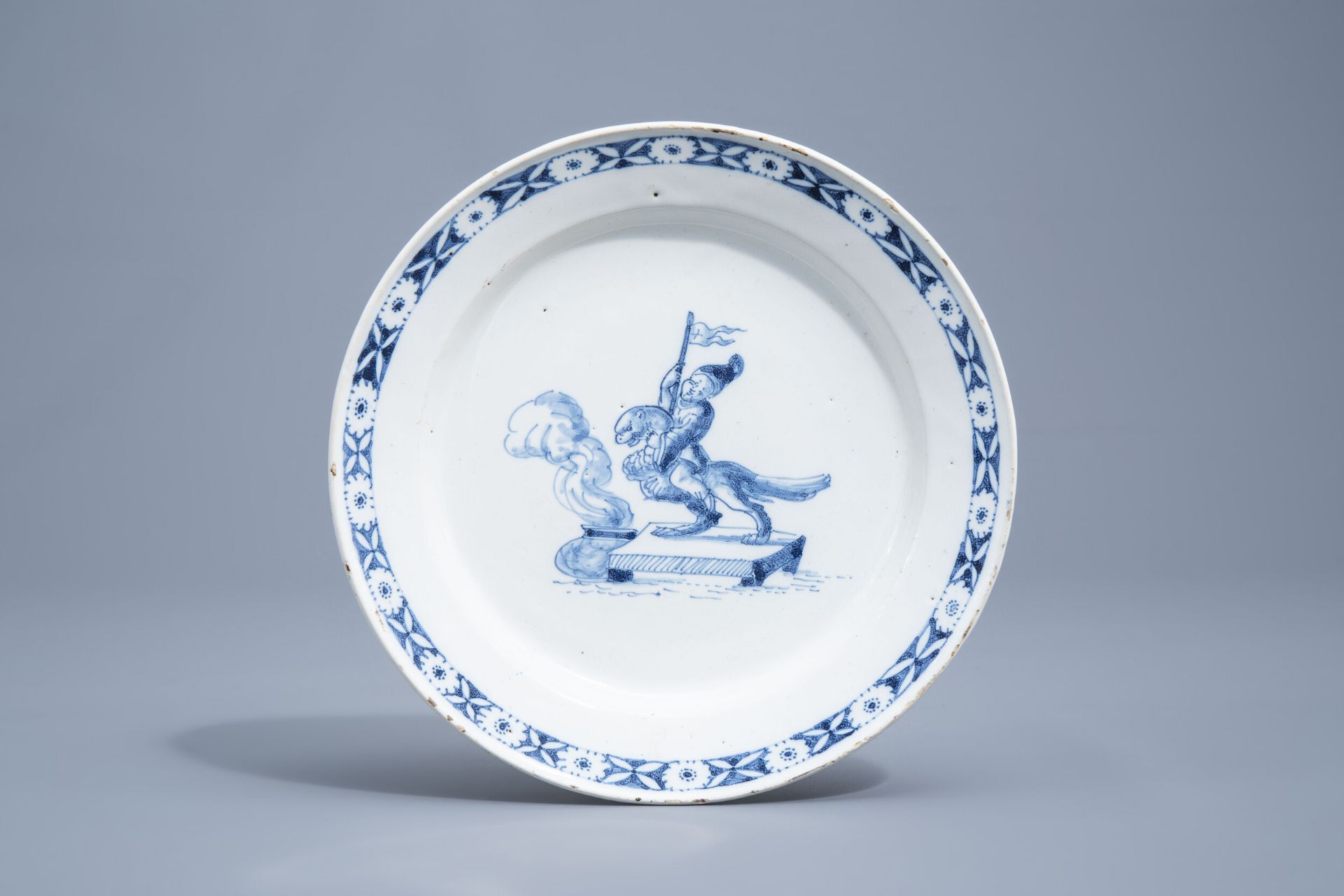 A blue and white pottery plate with a warrior on a griffin, probably Germany, 18th C.