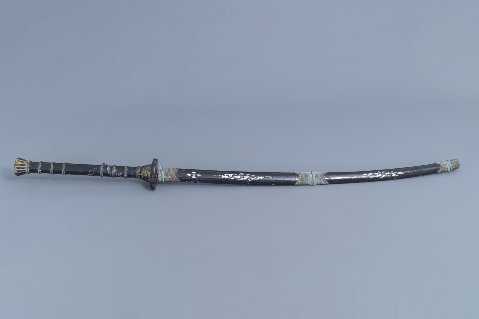 A large sword with scabbard in black lacquered wood with mother-of-pearl, China or Vietnam, 19th C.