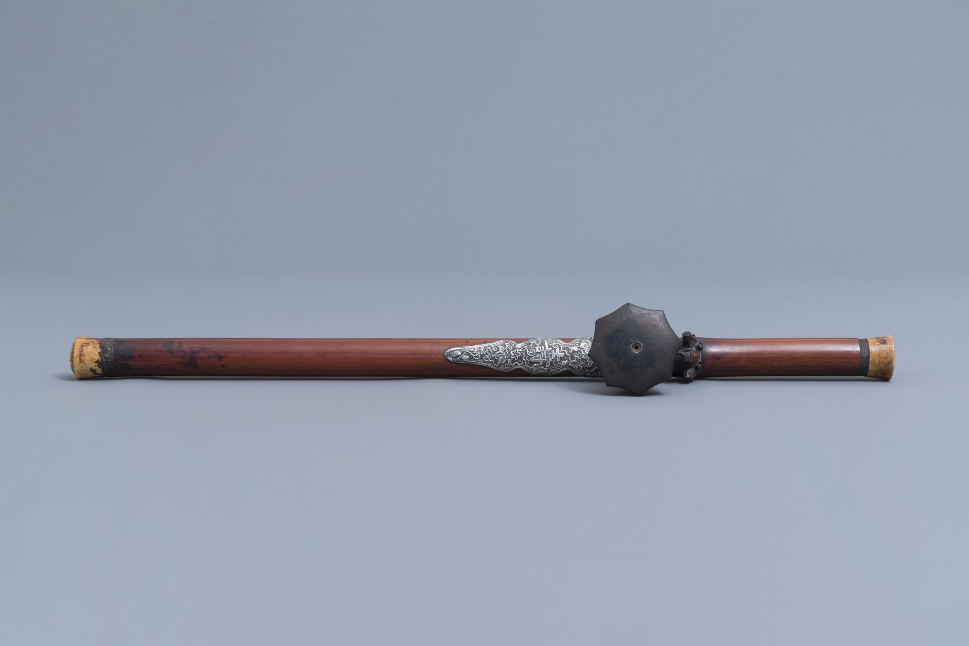 A Chinese bamboo opium pipe with a silver saddle, ivory endpiece and stoneware damper, 19th C. - Image 4 of 12