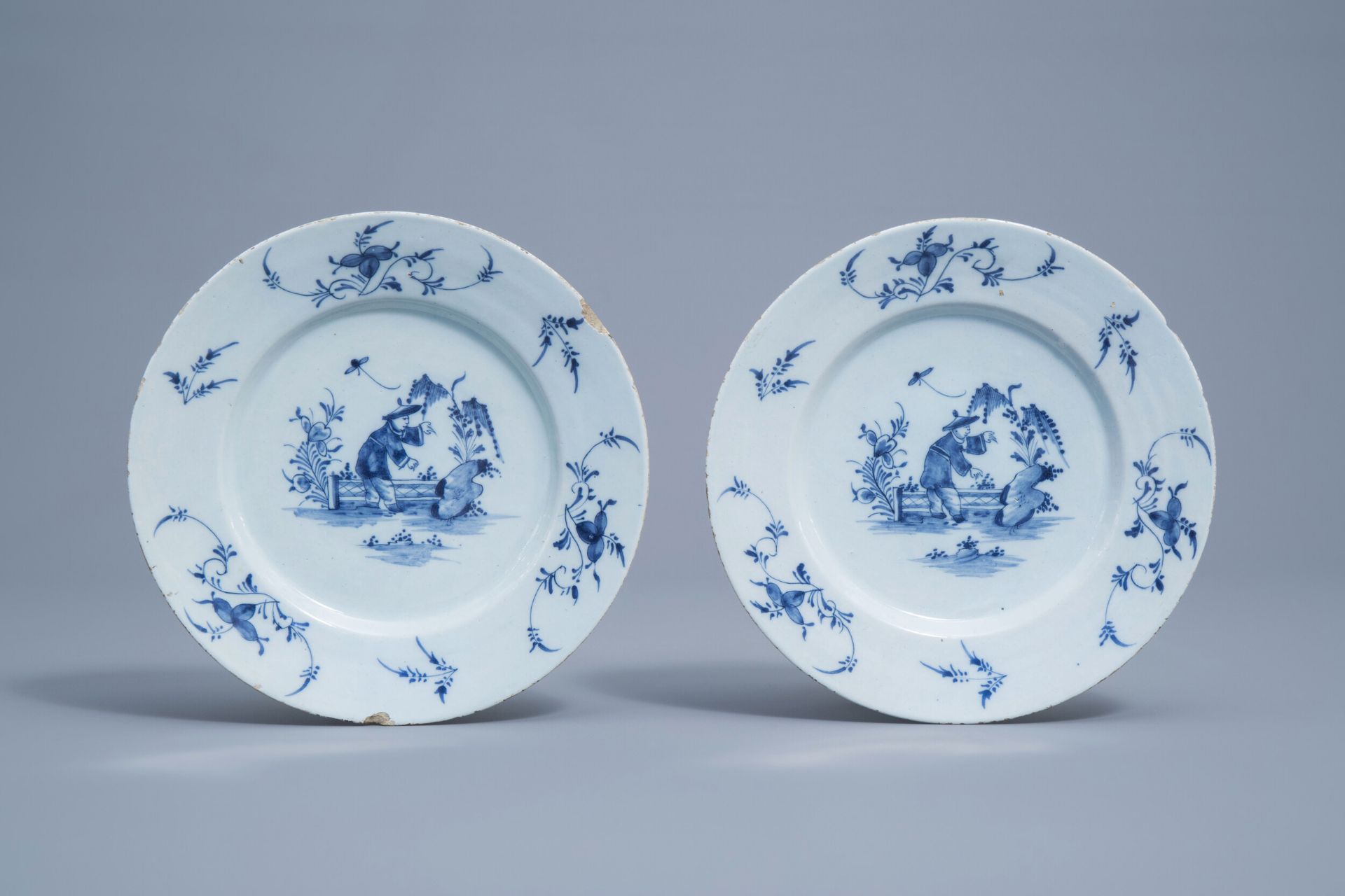 A pair of Dutch Delft blue and white 'chinoiserie' plates, 18th C.