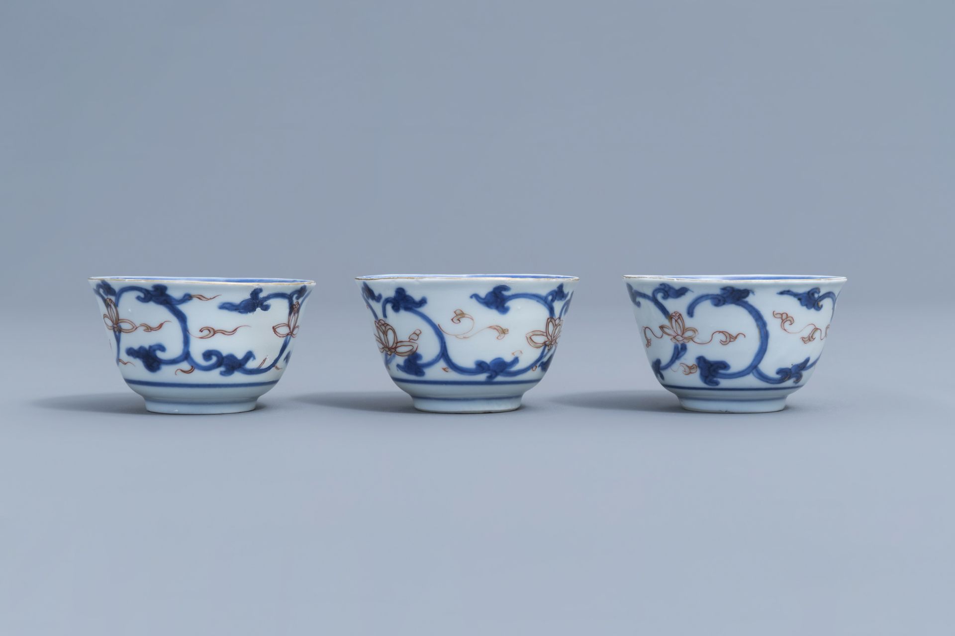 Six Chinese blue, white, iron red and gilt cups and saucers with floral design, Kangxi - Image 16 of 34