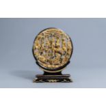A Chinese reticulated gilt wood 'battle scene' medallion on stand, 19th C.