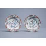 A pair of Chinese deep famille rose plates with figures and cranes, Yongzheng/Qianlong