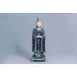 A large Chinese turquoise and aubergine glazed figure of a dignitary, Ming