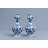 A pair of Dutch Delft blue and white vases with floral design, 18th C.