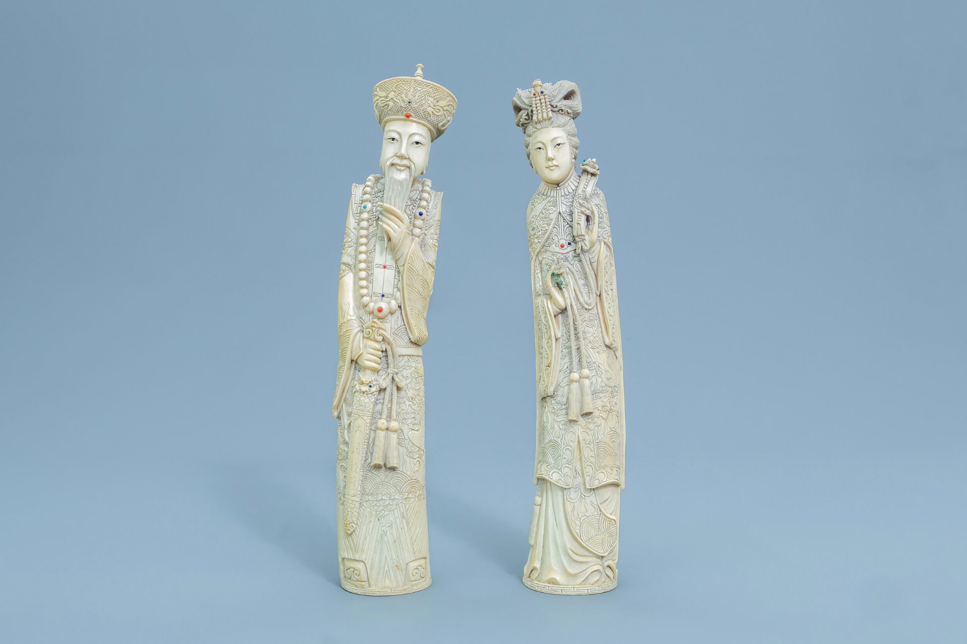 A pair of Chinese inlaid carved ivory figures of the emperor couple, first half of the 20th C.