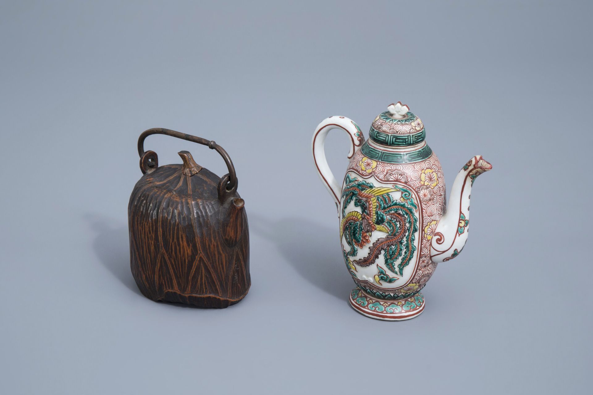 A Japanese Satsuma teapot and cover and one in carved wood, Meiji, 19th/20th C.