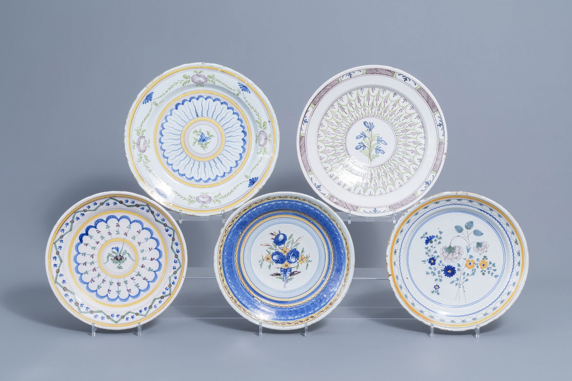 Five polychrome Brussels faience plates with floral design, 18th/19th C.