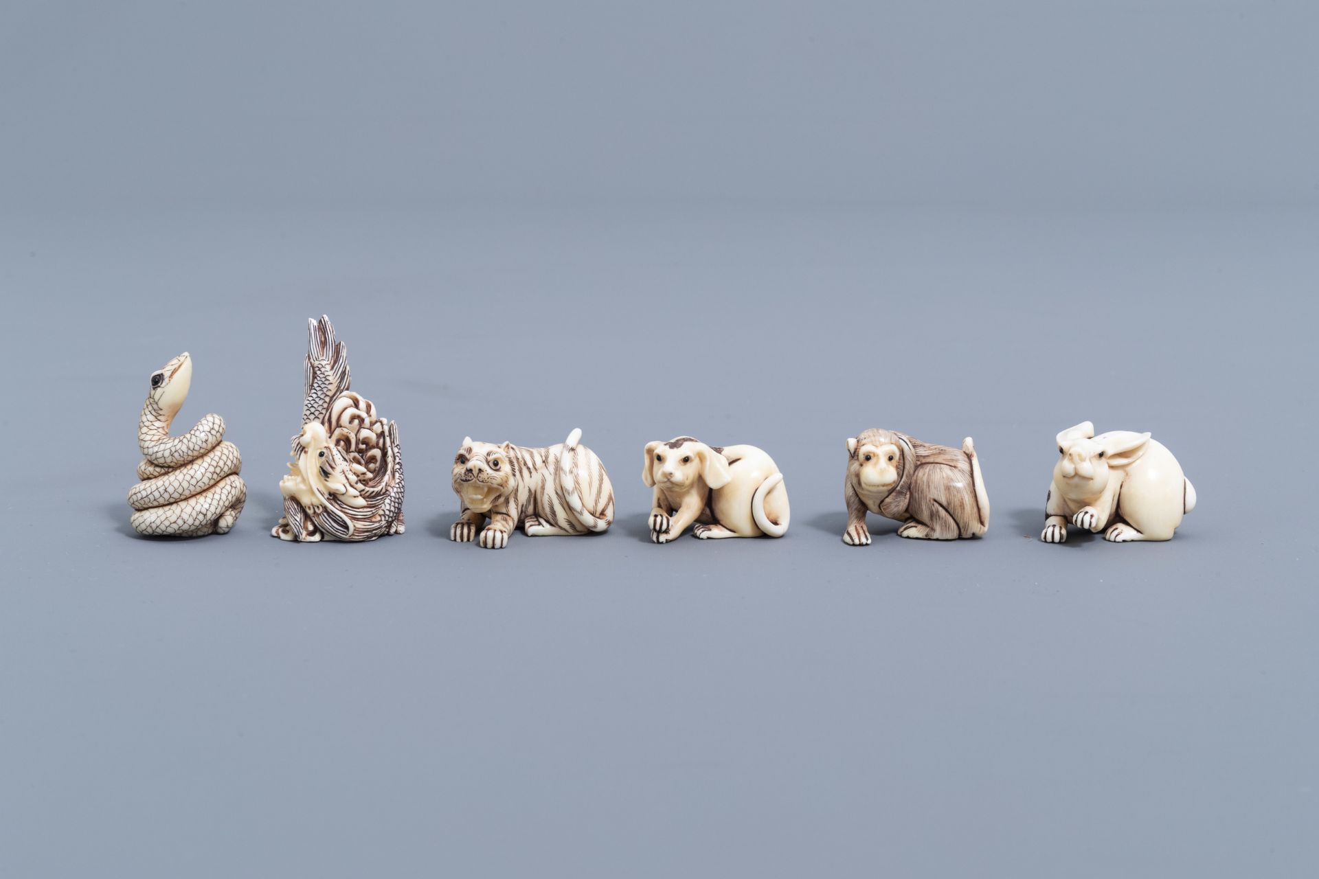 Twelve Japanese animal shaped netsuke in their display cabinet, first half of the 20th C. - Image 3 of 27