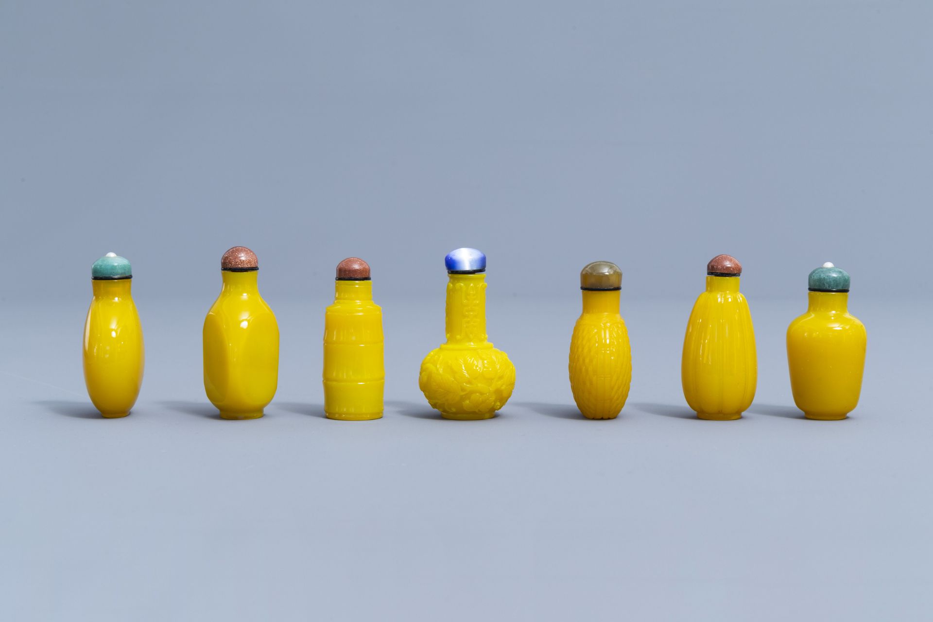 Thirteen Chinese yellow monochrome and overlay glass snuff bottles, 20th C. - Image 3 of 4