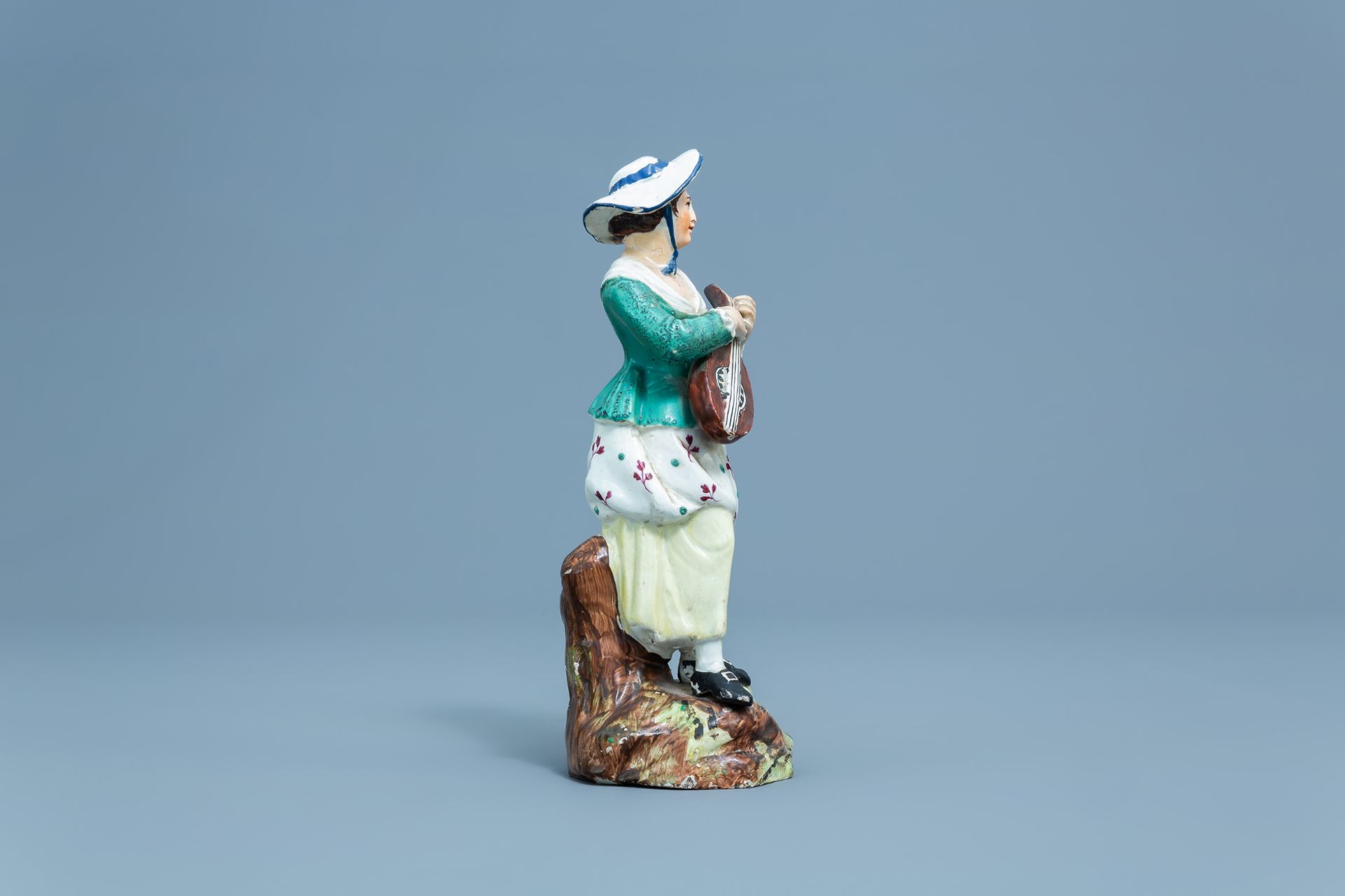 A German polychrome decorated earthenware figure of a lady with a mandolin, Hšchst, 18th C. - Image 3 of 7