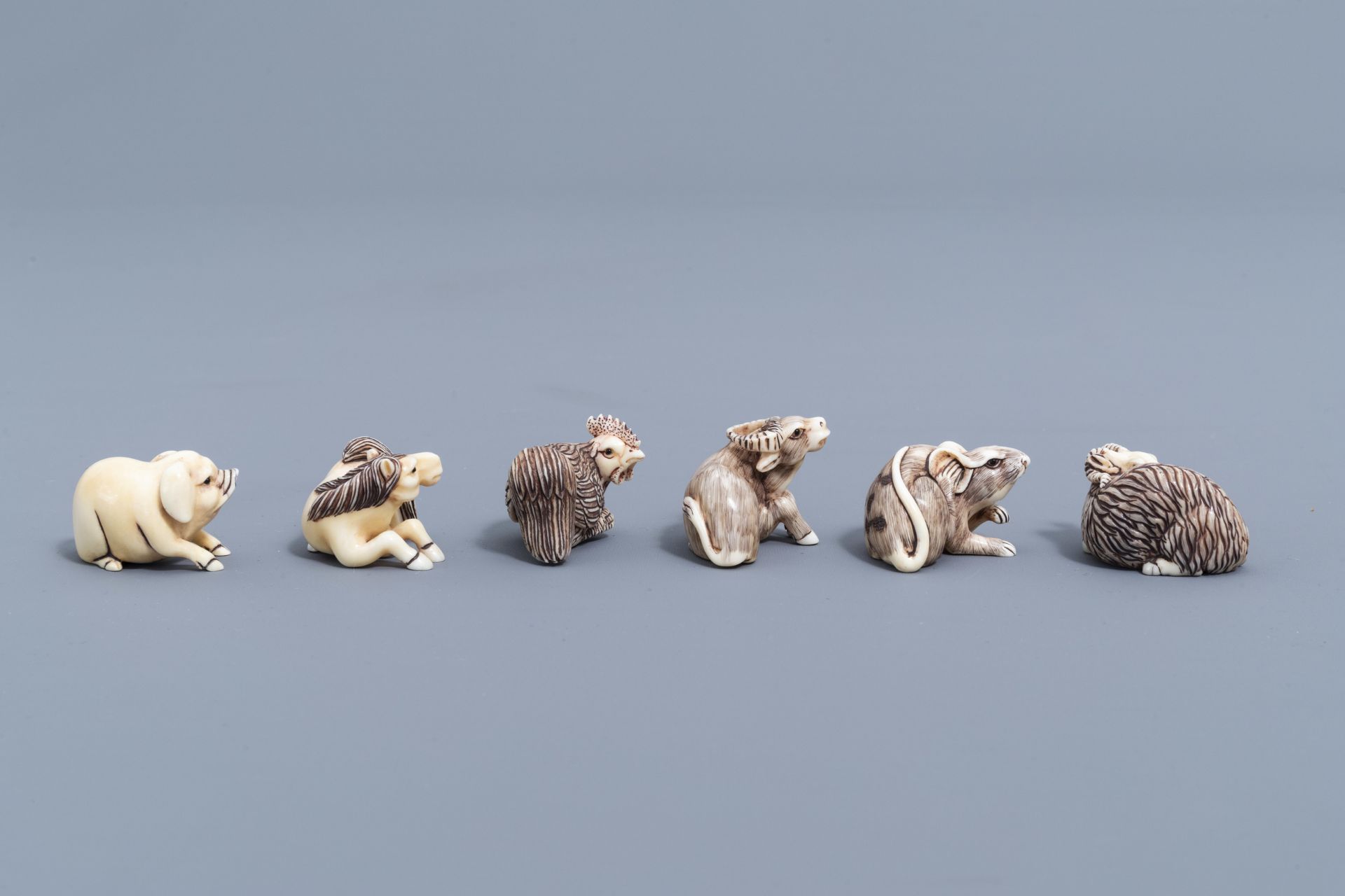 Twelve Japanese animal shaped netsuke in their display cabinet, first half of the 20th C. - Image 16 of 27