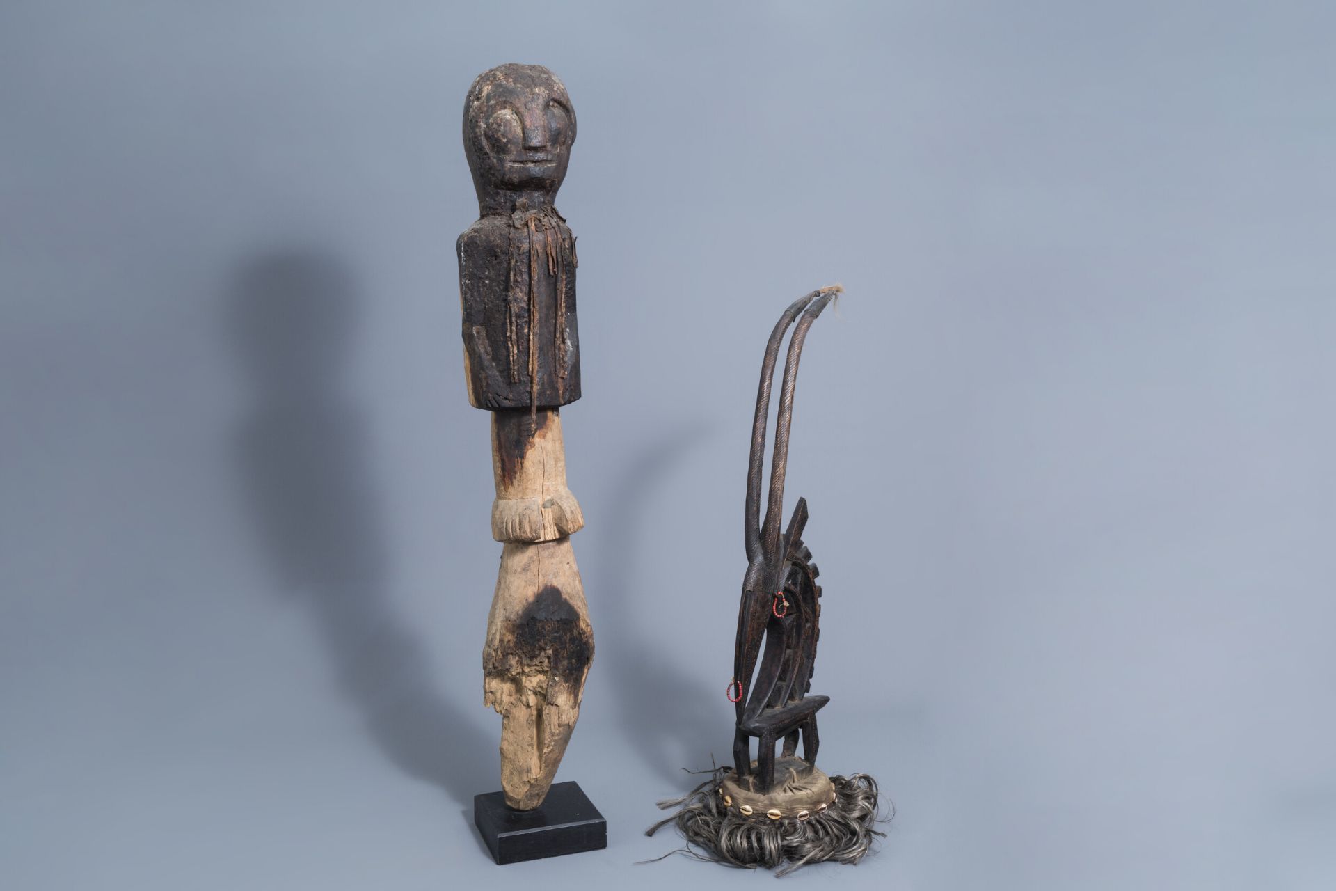 A Chi Wara headdress, Bamana, Mali, and a wooden person shaped sculpture, probably Mbembe, Nigeria,