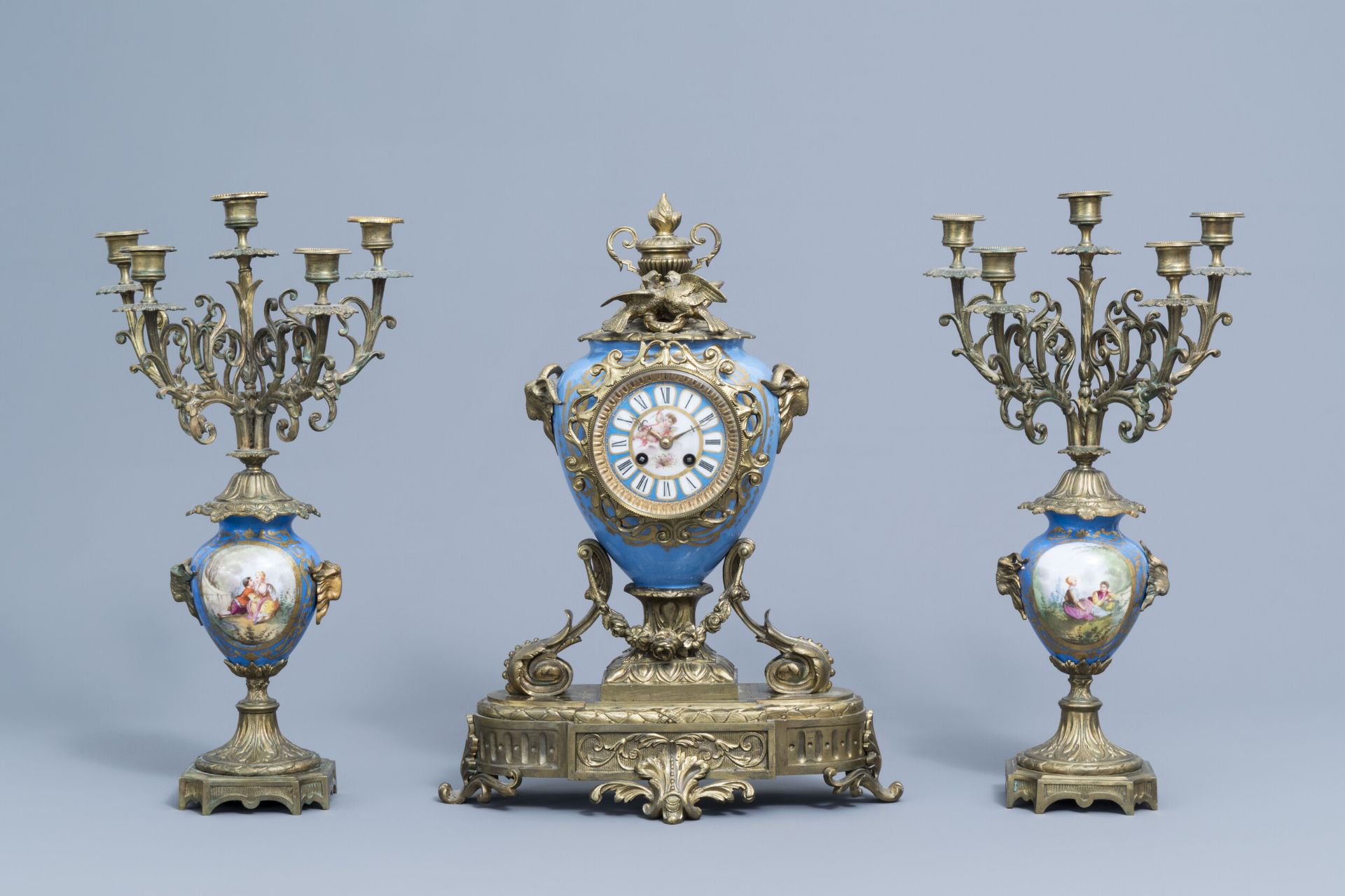 A French Historicism three-piece gilt mounted Sevres style clock garniture, 19th C.