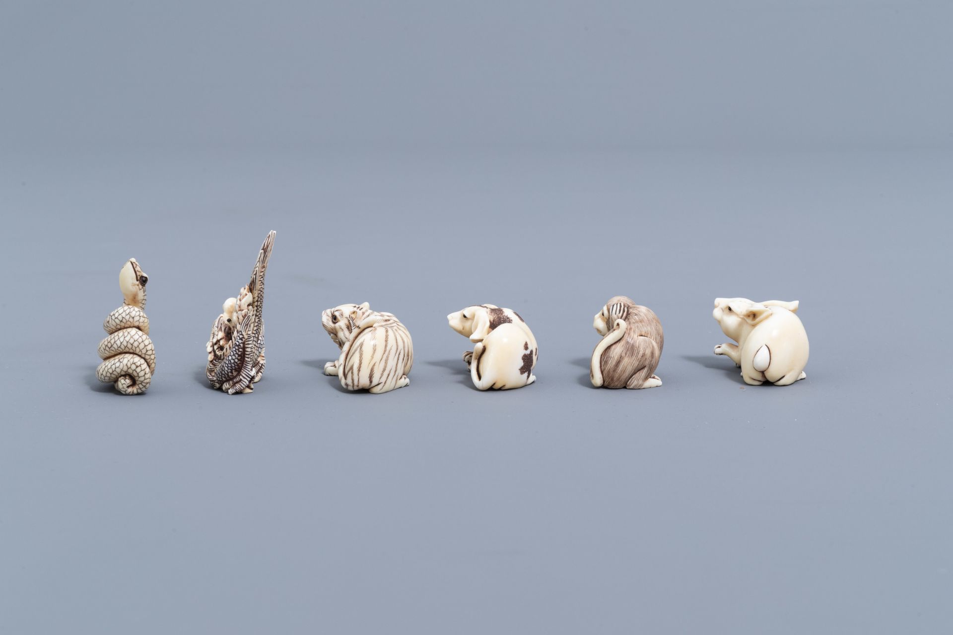 Twelve Japanese animal shaped netsuke in their display cabinet, first half of the 20th C. - Image 6 of 27