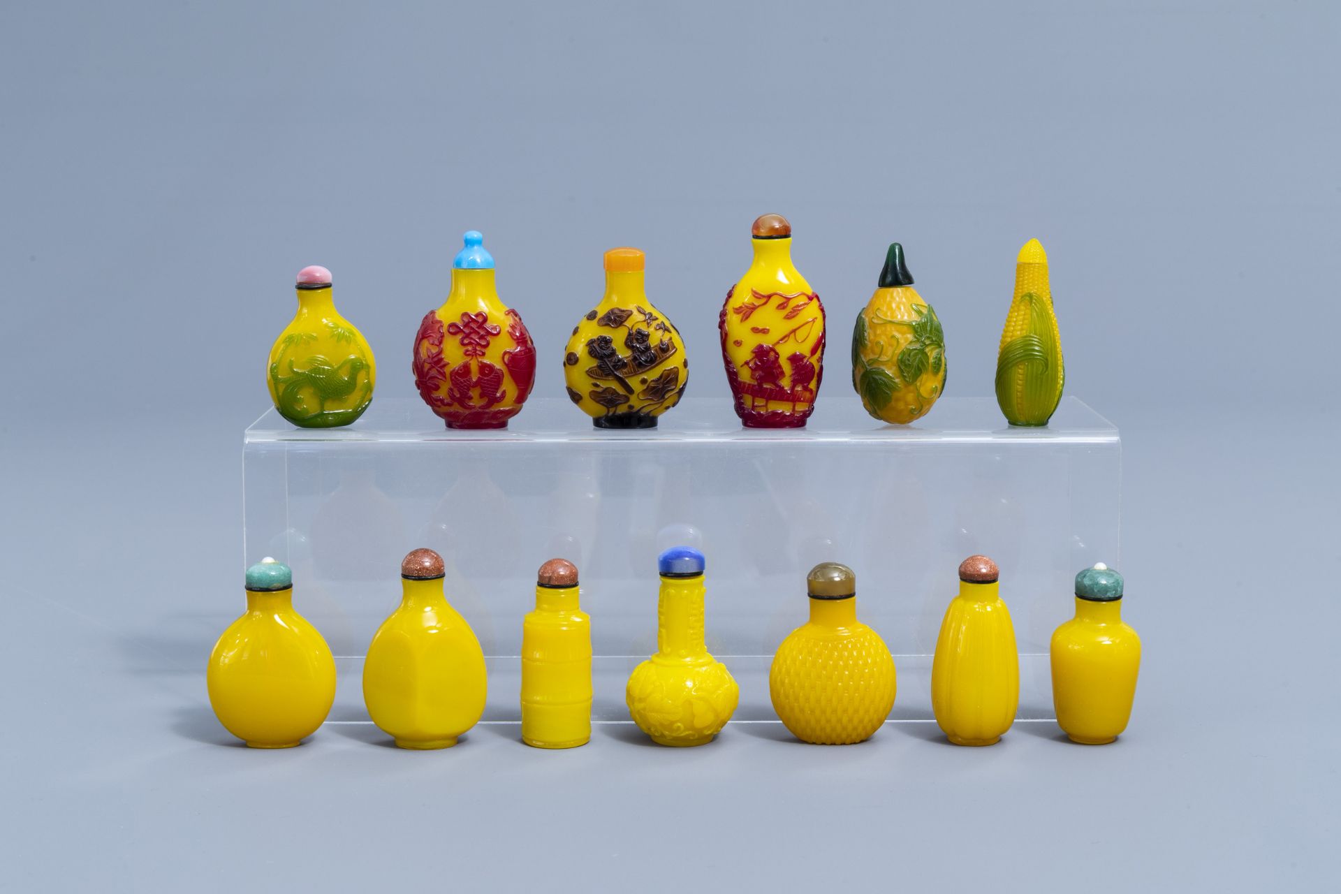 Thirteen Chinese yellow monochrome and overlay glass snuff bottles, 20th C.