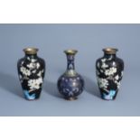 A pair of Chinese cloisonne vases with floral design and a bottle vase, 19/20th C.