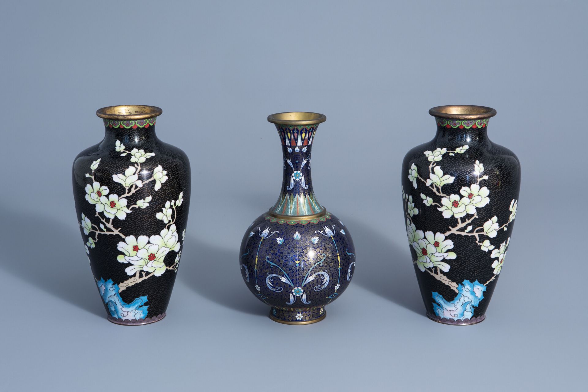 A pair of Chinese cloisonne vases with floral design and a bottle vase, 19/20th C.