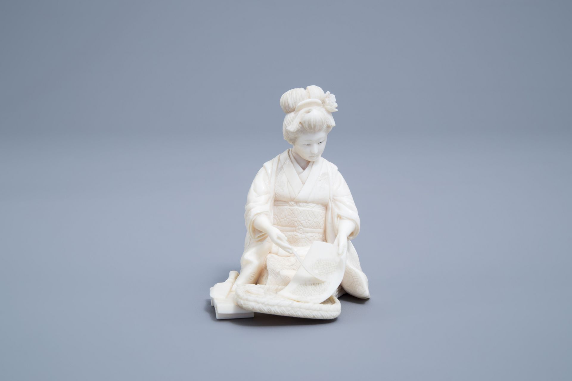 A signed Japanese ivory ikomono of a lady at work, Meiji, 19th/20th C. - Image 2 of 8