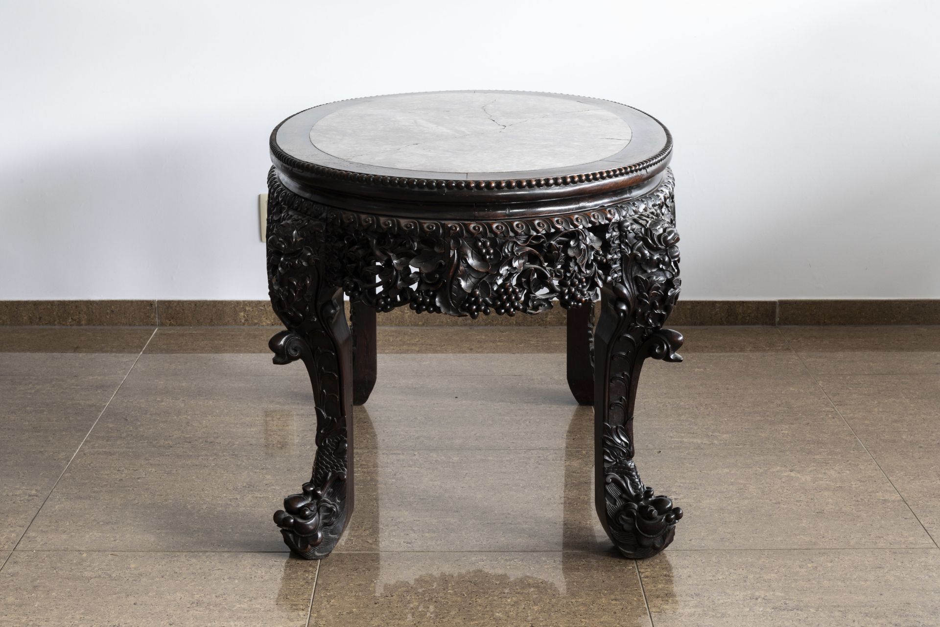 An oval Chinese finely carved wooden table with marble top, 19th C. - Image 3 of 6