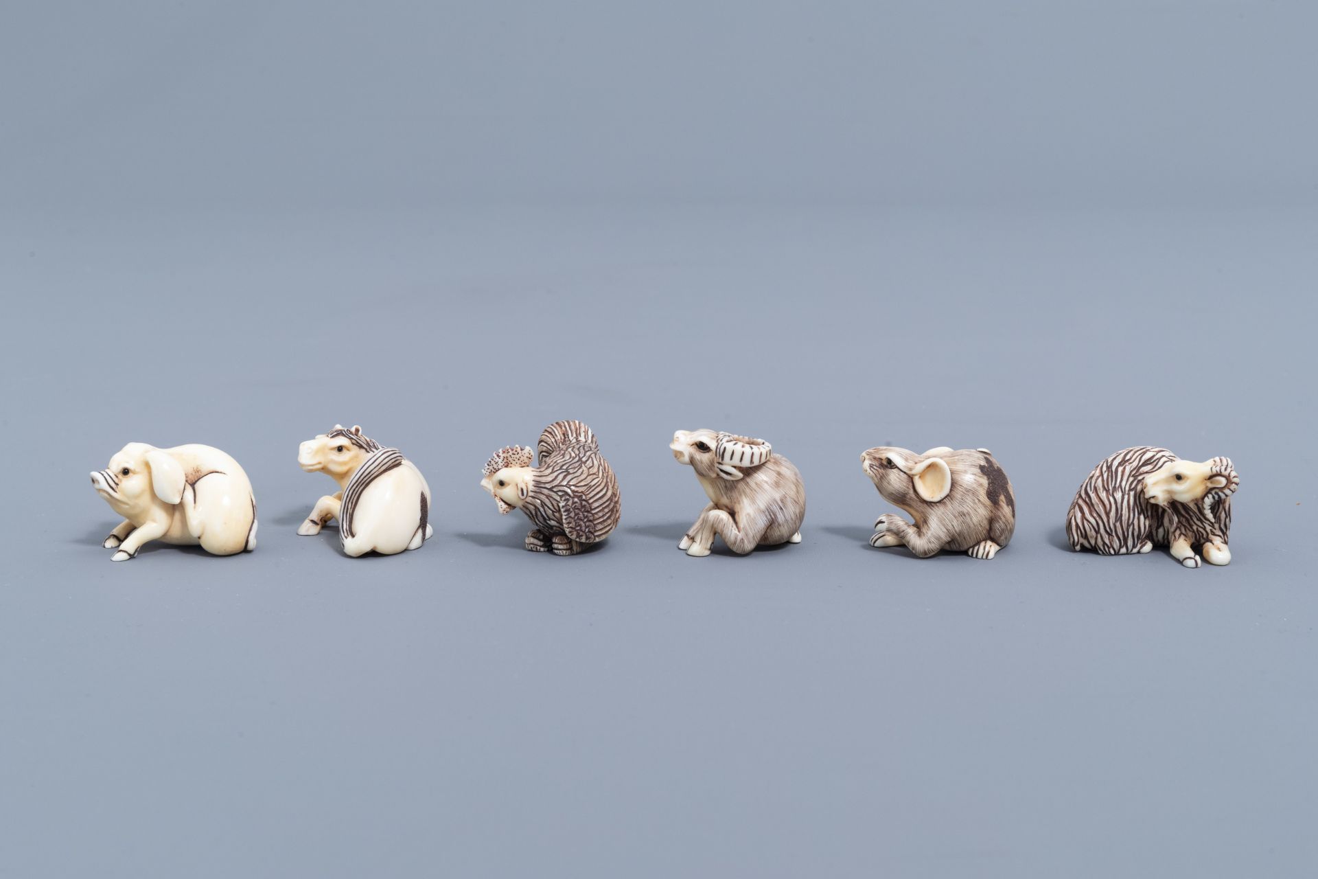 Twelve Japanese animal shaped netsuke in their display cabinet, first half of the 20th C. - Image 18 of 27