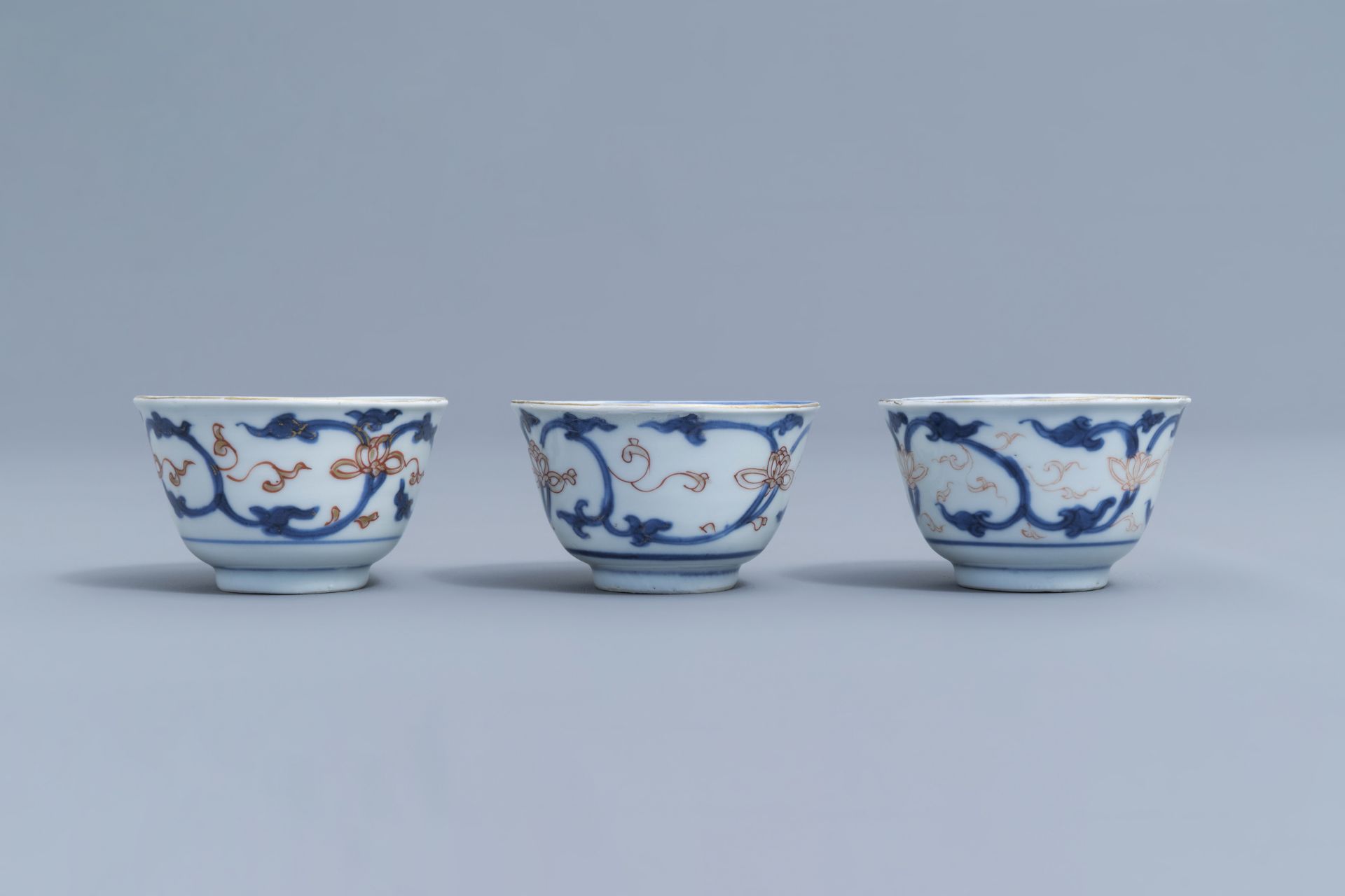 Six Chinese blue, white, iron red and gilt cups and saucers with floral design, Kangxi - Image 29 of 34