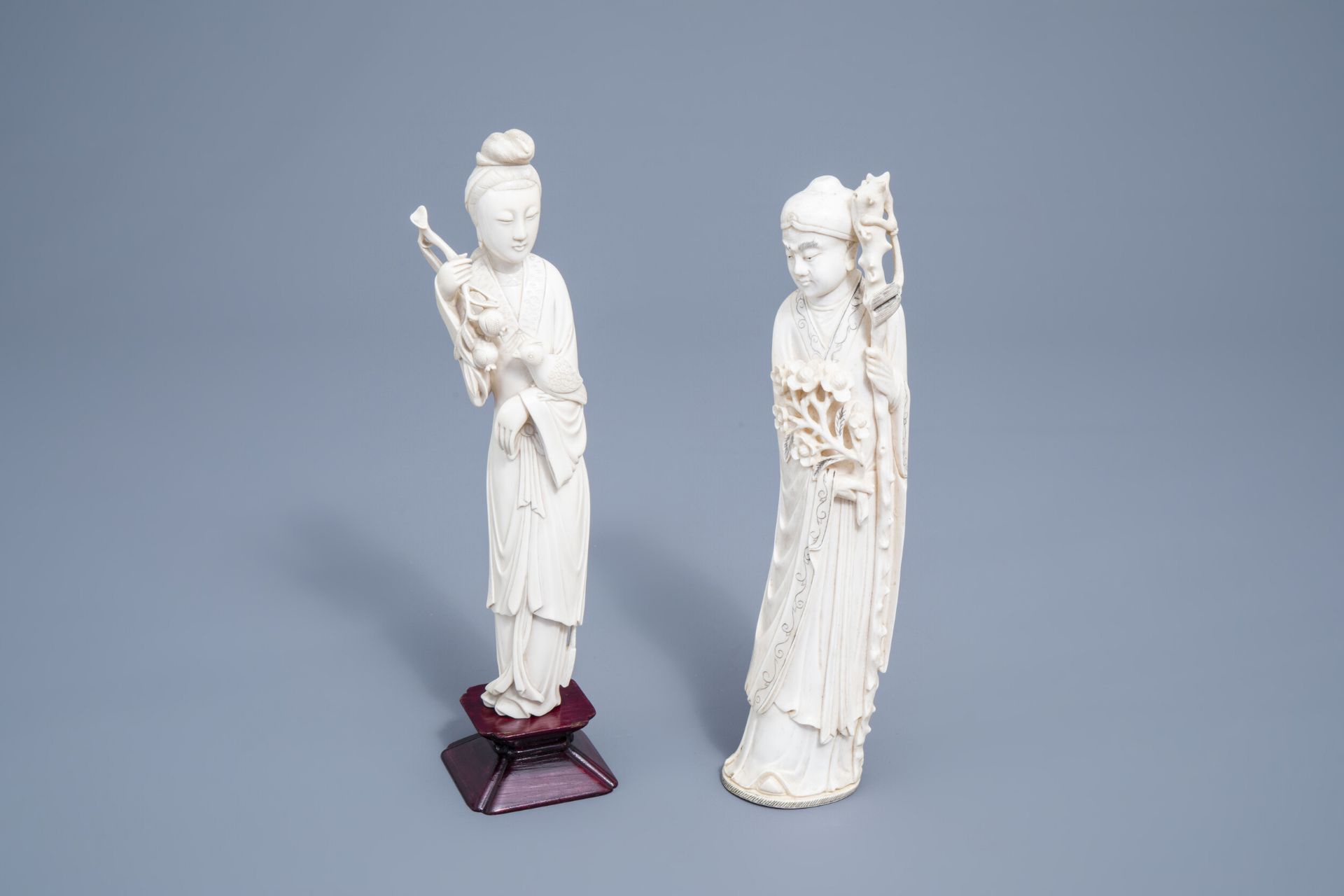 Two Chinese carved ivory figures of a scholar and a lady with a parrot, 19th/20th C.