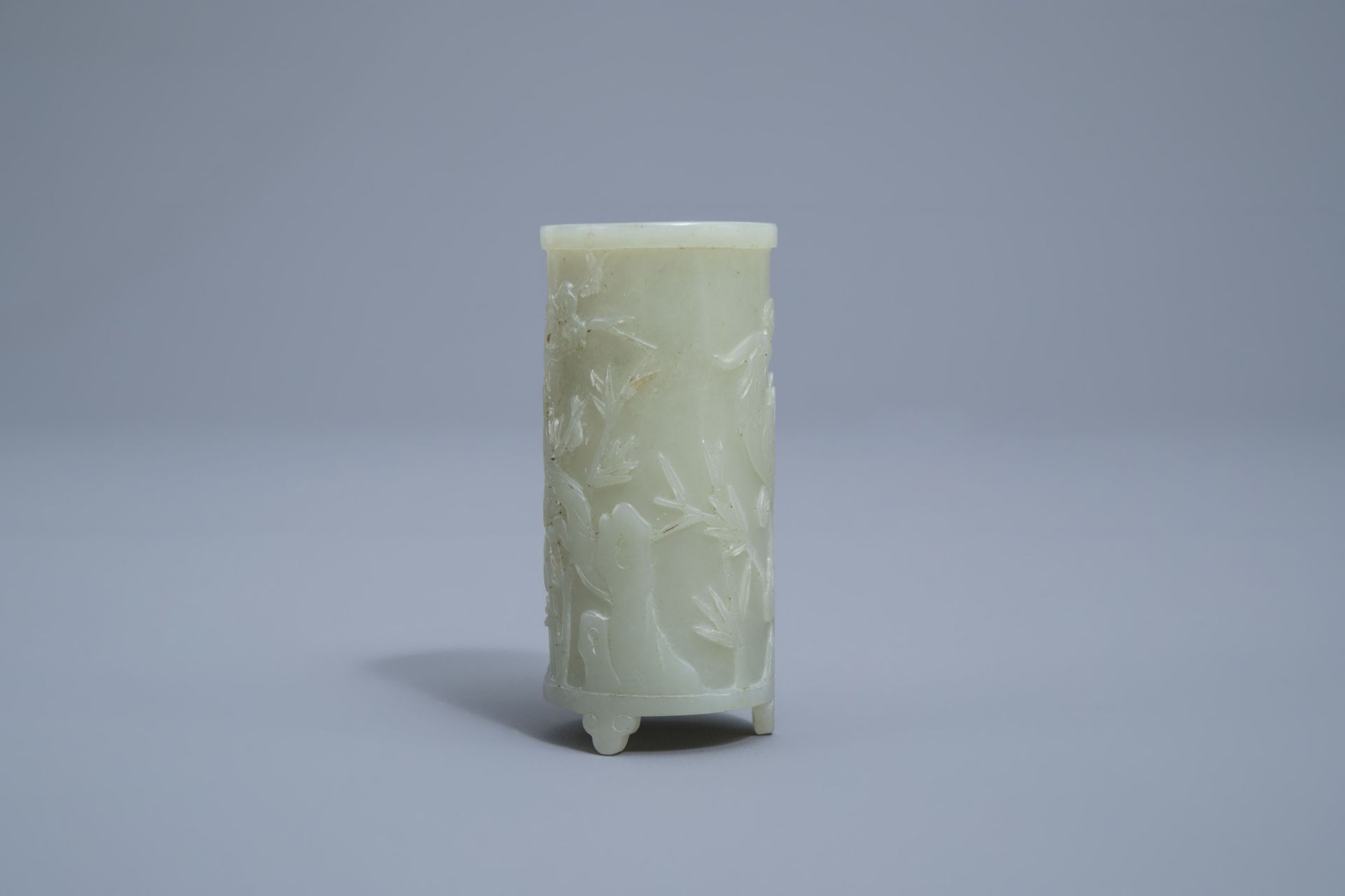 A Chinese celadon jade tripod brush pot with a phoenix among blossoming branches, 19th C. - Image 2 of 4