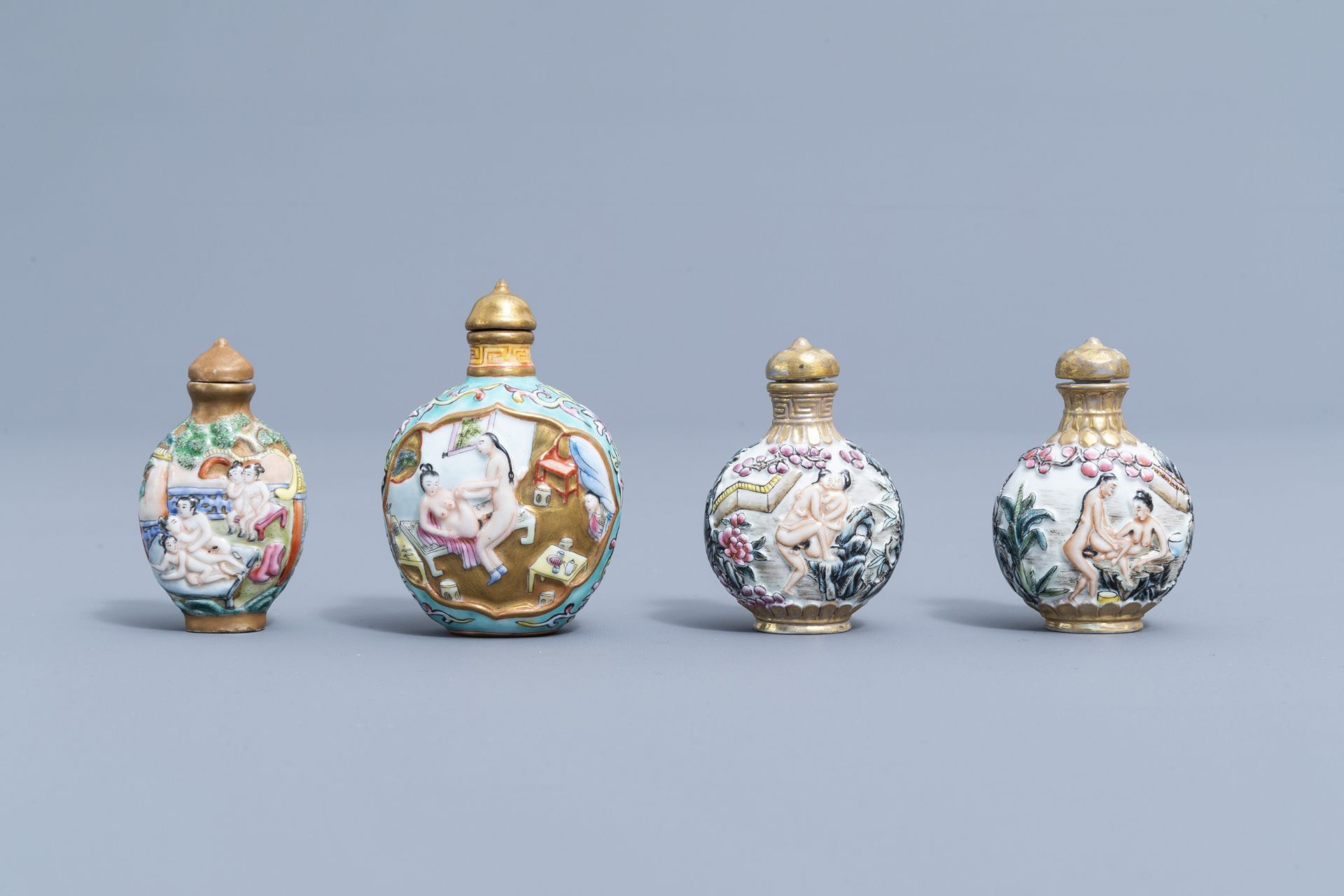 Eight Chinese erotical porcelain, glass and Canton enamel snuff bottles, 20th C.